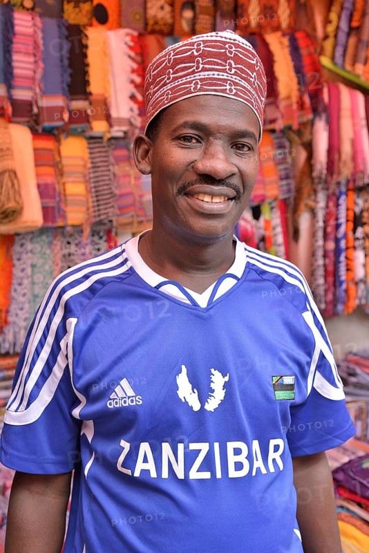 Clothing merchant wearing a football jersey of the Zanzibar Heroes, Stone Town, Zanzibar City, Zanzibar, Tanzania, Africa
