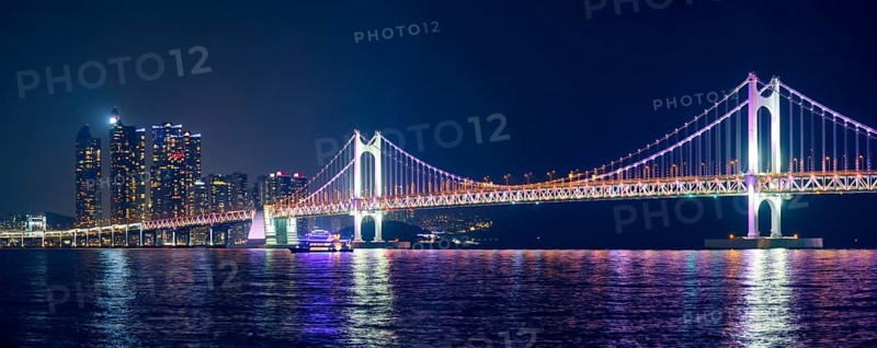 Panorama of Gwangan Bridge and skyscrapers illuminated in the night. Busan, South Korea, Asia