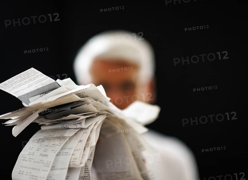 The subject of taxes. A man holds receipts in his hand in Berlin, 09/08/2024