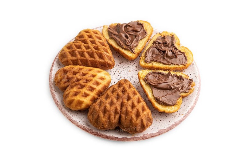Homemade waffle with chocolate butter isolated on white background. side view, close up