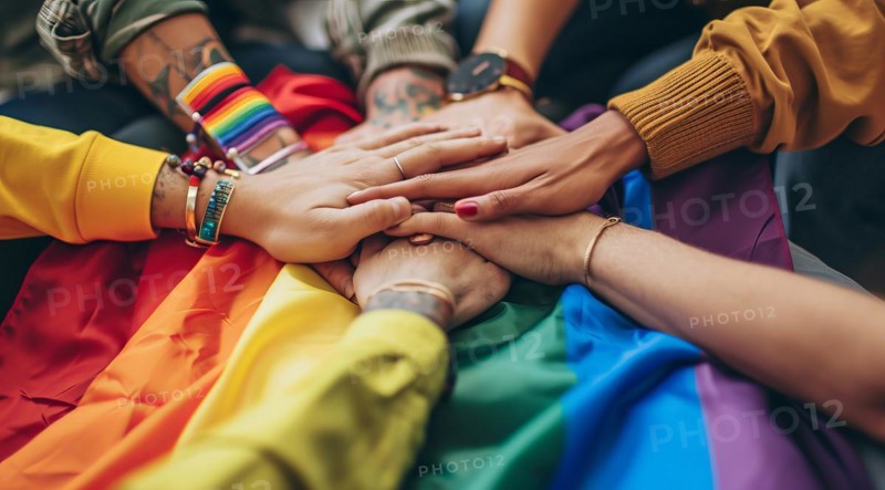 Diverse people hands over rainbow LGBTQ flag showing love, affection and unity, AI generated