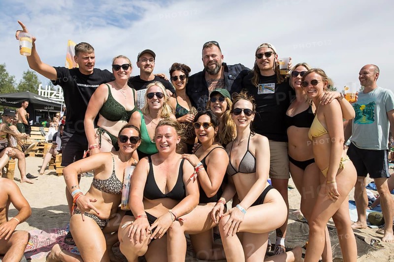 The band Feine Sahne Fischfilet having their photo taken with fans on the beach at the Highfield Festival on Saturday, Störmthaler See, 17/08/2024