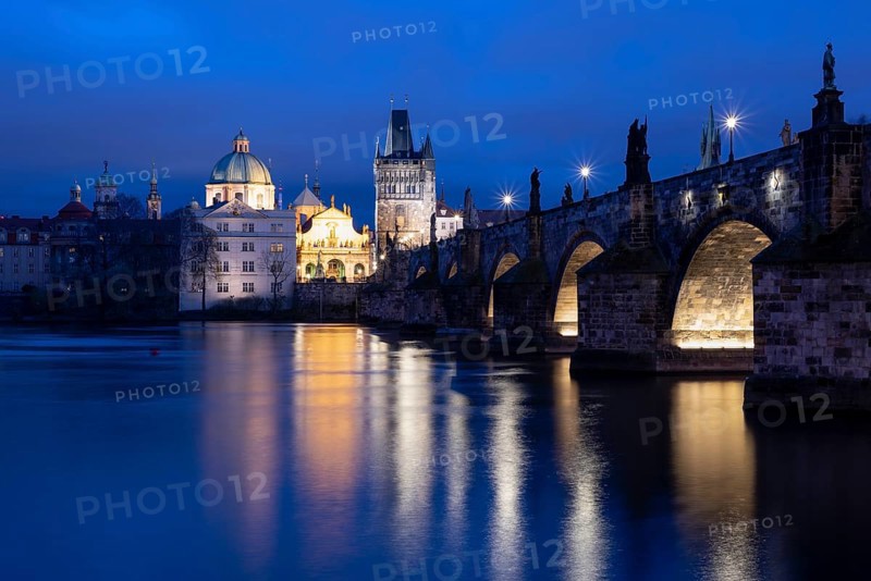 Charles Bridge with the Old Town Bridge Tower and the Church of the Holy Cross at the blue hour, Prague, Czech Republic, Europe