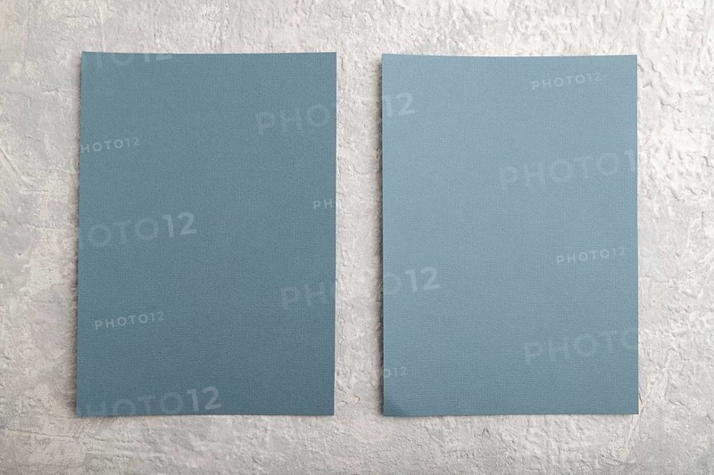 Blue paper business card, mockup on gray concrete background. Blank, flat lay, top view, still life, copy space