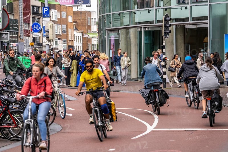 Central cycle path on the Lange Viestraat, in the centre of Utrecht, lanes for pedestrians, cyclists and cars are separated, heavy traffic, Netherlands