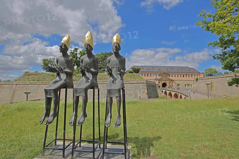 Sculpture Enthroned by Volkmar Kühn 2021, three bishops with golden mitres sitting on stools, row, arms outstretched, frame, mitre, commander's house, bastion, city fortification, citadel, Petersberg, Erfurt, Thuringia, Germany, Europe