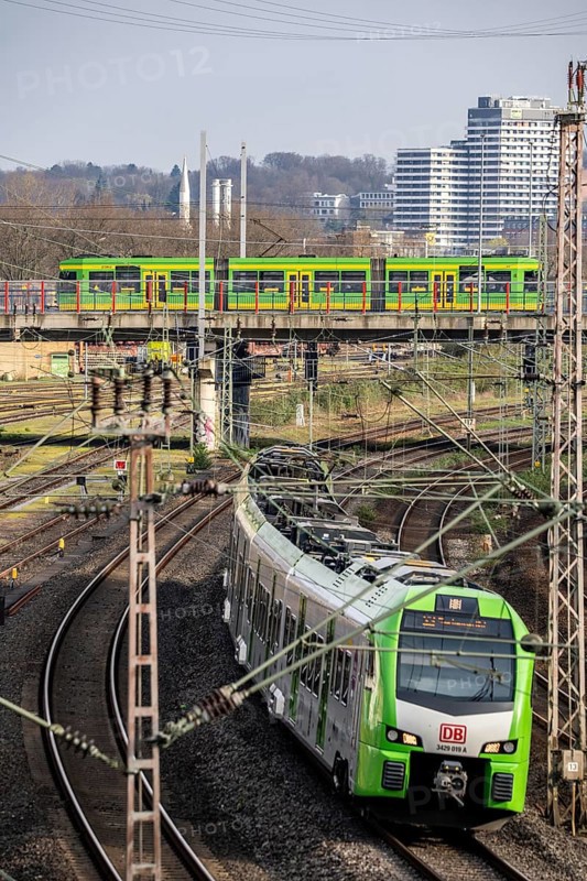 Tram line 112 on bridge, S-Bahn train on railway line between Mülheim an der Ruhr, in the background and Duisburg, busy railway line, for local and long-distance traffic, freight traffic, North Rhine-Westphalia, Germany, Europe