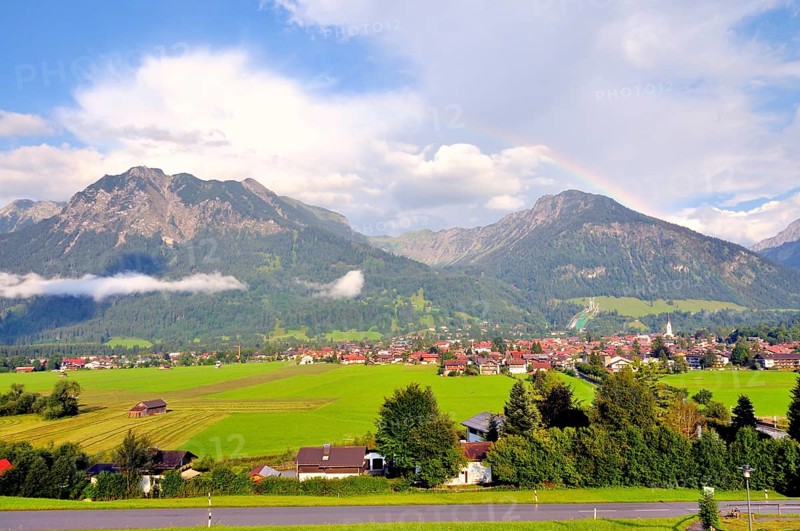 View over Oberstdorf with rainbow on Rubihorn and Geißalphorn, Schattenberg on the right, Oberallgäu, Bavaria, Germany, Europe