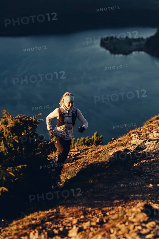Trail running in autumn on the Jochberg on Lake Walchensee against the wonderful backdrop of the Alps, Bavaria, Germany, Europe