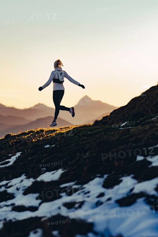 Trail running in autumn on the Jochberg on Lake Walchensee against the wonderful backdrop of the Alps, Bavaria, Germany, Europe