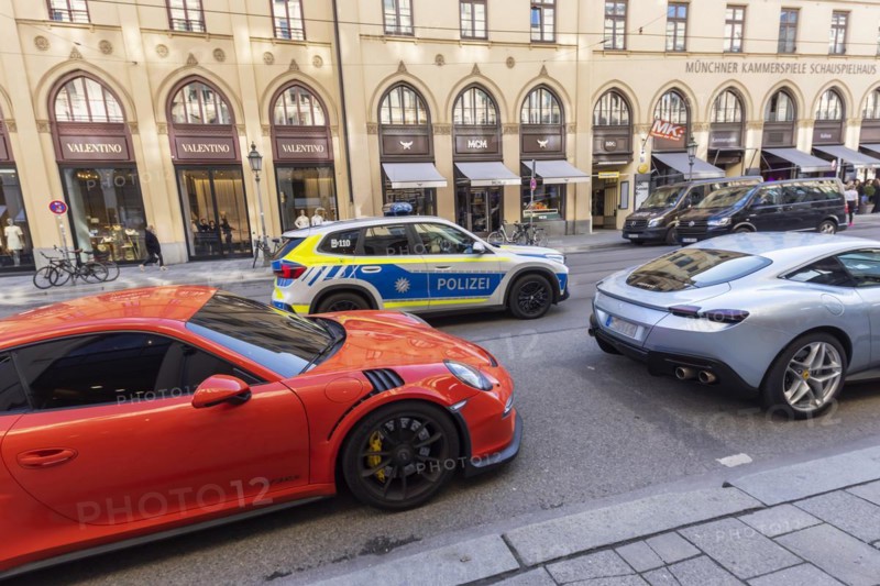 Maximilianstraße Munich on a normal Saturday, Ferrari and other luxury cars on the fashionable and exclusive shopping mile, police car, Munich, Bavaria, Germany, Europe