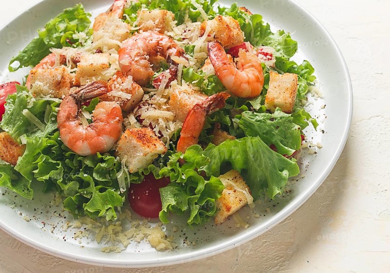 Caesar salad, with shrimp, on a white background, homemade, no people