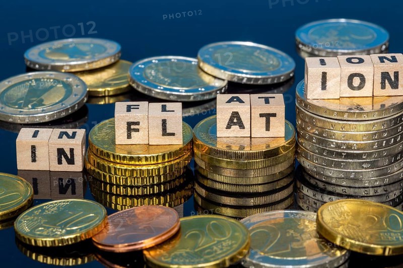 Symbolic image of inflation: euro coins and letters displaying the word INFLATION