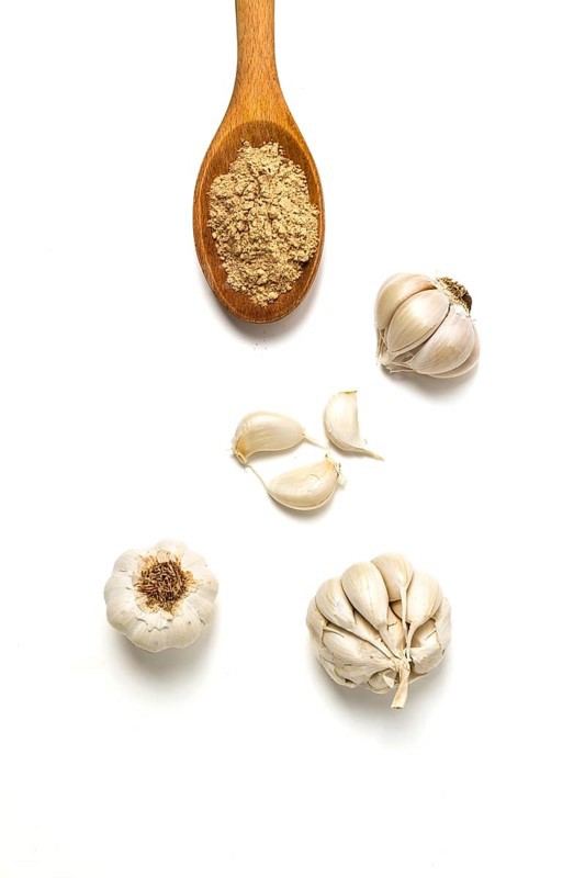 Spice ground garlic, on a white background, close-up, no people, selective focus