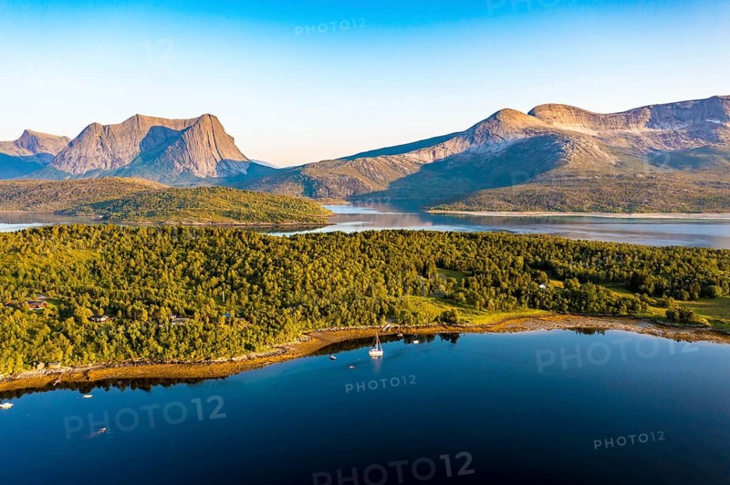 Aerial view over the fjord Efjord south of Narvik, seen at sunset, leisure boats anchor, holiday huts, calm sea, Norway, Europe