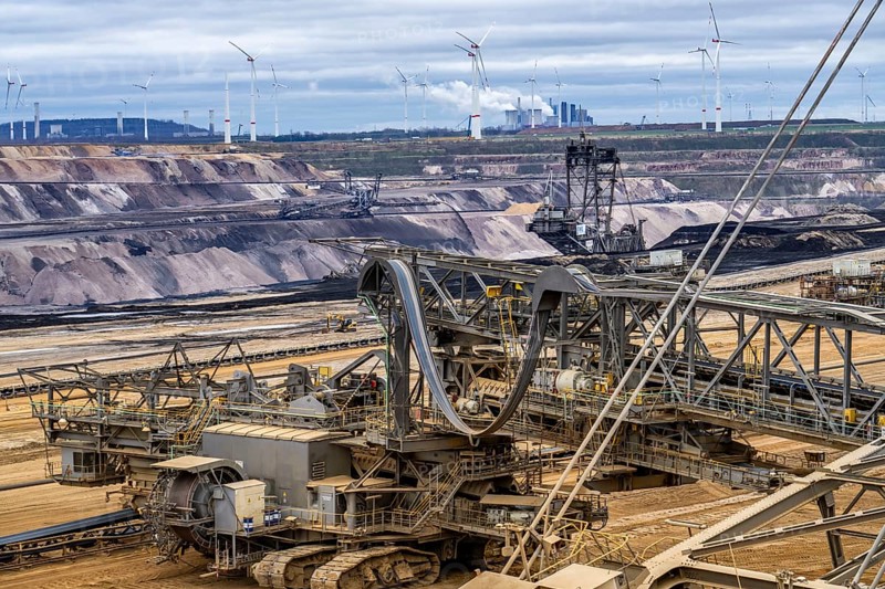 Opencast lignite mine Garzweiler 2, bucket wheel excavator 261 excavating the surface, at the rest of the hamlet of Lützerath, behind excavator 288, mining lignite, Neurath lignite-fired power station, wind farm, Erkelenz, North Rhine-Westphalia, Germany, Europe