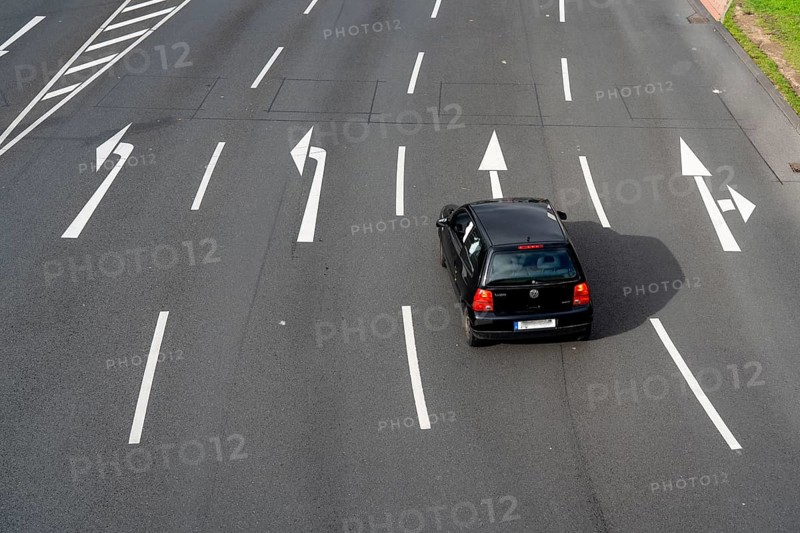 Road markings, turning lanes, directional signage at an intersection, turning, straight ahead, North Rhine-Westphalia, Germany, Europe