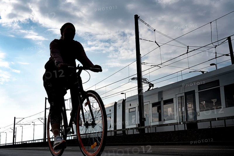 Cycling in the city, cyclist on the Deutzer Bridge in Cologne, tram, cycle path, North Rhine-Westphalia, Germany, Europe