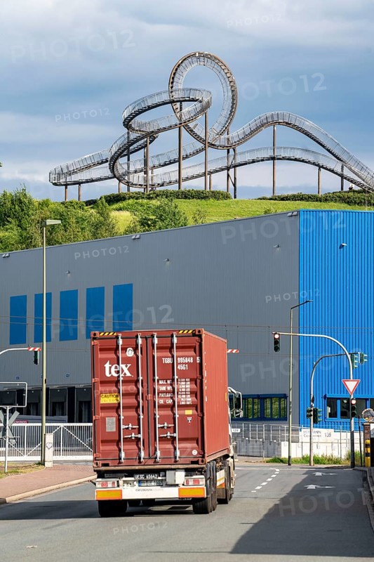 Landmark Tiger and Turtle - Magic Mountain, on the Heinrich-Hillebrand-Höhe in the Angerpark in Duisburg-Angerhausen, in front of it logistics centre, container trucks coming from the Rhein-Ruhr Container Terminal, on the Rhine North Rhine-Westphalia, Germany, Europe