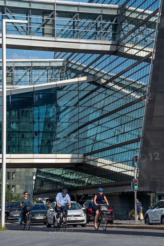 Cyclists on the cycle path on Christians Brygge Street, at the Black Diamond, Danish Royal Library, Copenhagen is considered the cycling capital of the world, 45 % of the population travel by bike, Denmark, Europe