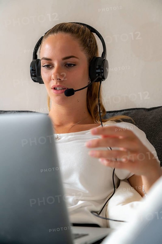 Young student learns at home, online, in conversation with other students