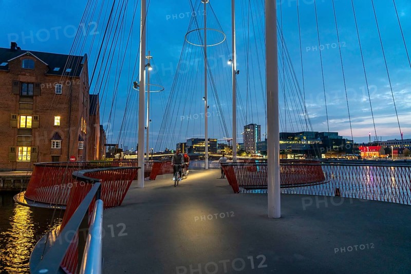 Cyclists on the Cirkelbroen cycle and pedestrian bridge, over the harbour, in the Christianshavens district, Copenhagen is considered the cycling capital of the world, 45 % of the population travel by bike, Denmark, Europe