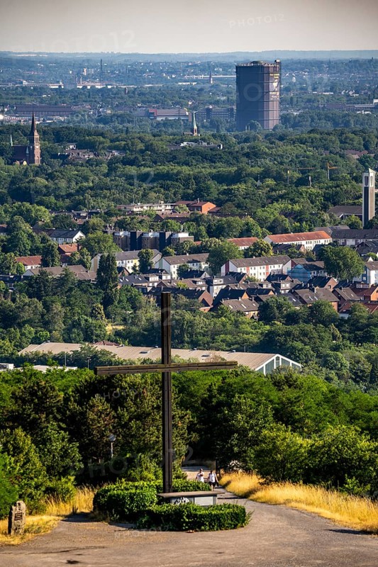 View of Oberhausen with the gasometer, from the Haniel spoil tip, summit cross at the altar of the Way of the Cross on the spoil tip, North Rhine-Westphalia, Germany, Europe
