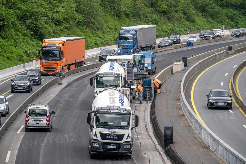 Motorway construction site on the A52 in Essen, basic renovation of the two carriageways in both directions, over 8 years, here the construction of concrete crash barriers between the carriageways, using the so-called sliding construction method, around 500 metres of concrete crash barrier, crash barrier is built per day, North Rhine-Westphalia, Essen