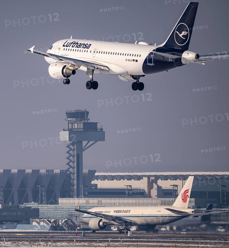 Lufthansa Airbus A319-100 approaching Frankfurt FRA airport, air traffic control tower, Fraport, in winter, Hesse, Germany, Europe