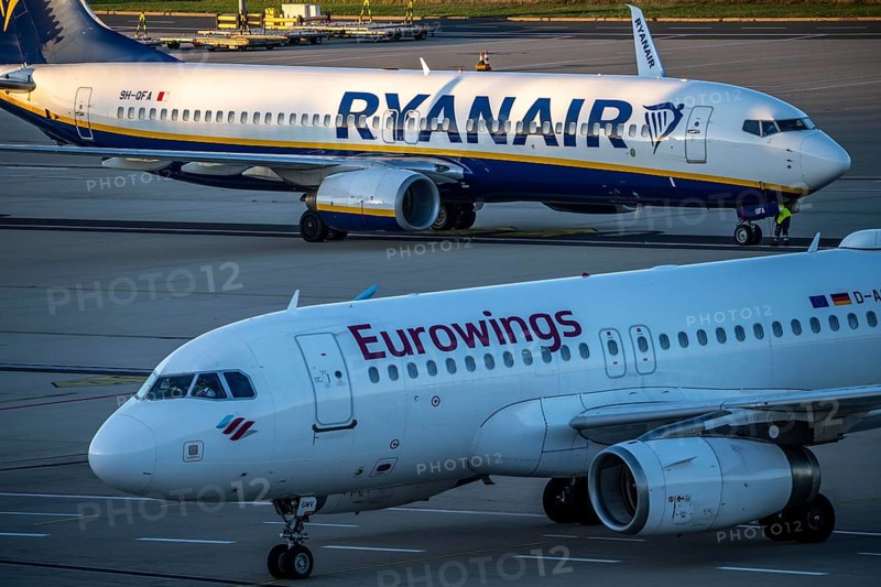 Eurowings Airbus A319 after landing on the way to Terminal 1, C-Gates, Ryanair Boeing 737 taxiing to the runway, Cologne-Bonn Airport, CGN, North Rhine-Westphalia, Germany, Europe