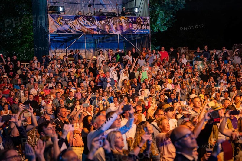 Large crowd at night concert with stage and welcome banner in the background, Klostersommer, Calw Hirsau, Black Forest, Germany, Europe