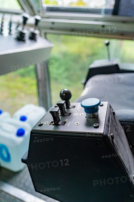 Control unit with a blue button and two levers in front of a window front, Hermann Hesse Bahn track construction, Calw district, Black Forest, Germany, Europe
