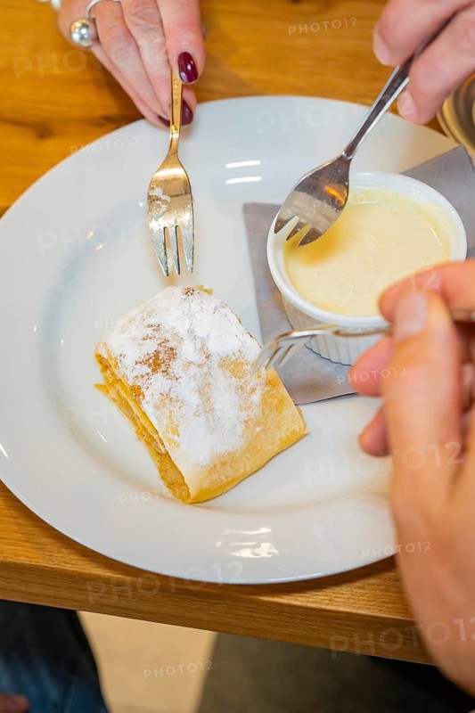 Apple strudel with icing sugar, served with vanilla sauce, two forks on a plate, autumn creations at Cafe Kuh, Deckenpfronn, Germany, Europe