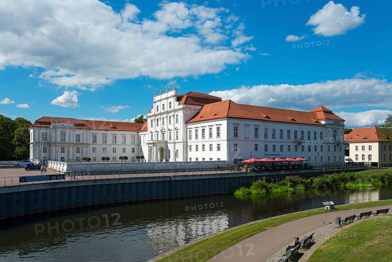 A large baroque palace with red roofs next to a peaceful river and park, Oranienburg Palace, Museum, Oranienburg, Havel River, Oberhavel district, Brandenburg, Germany, Europe