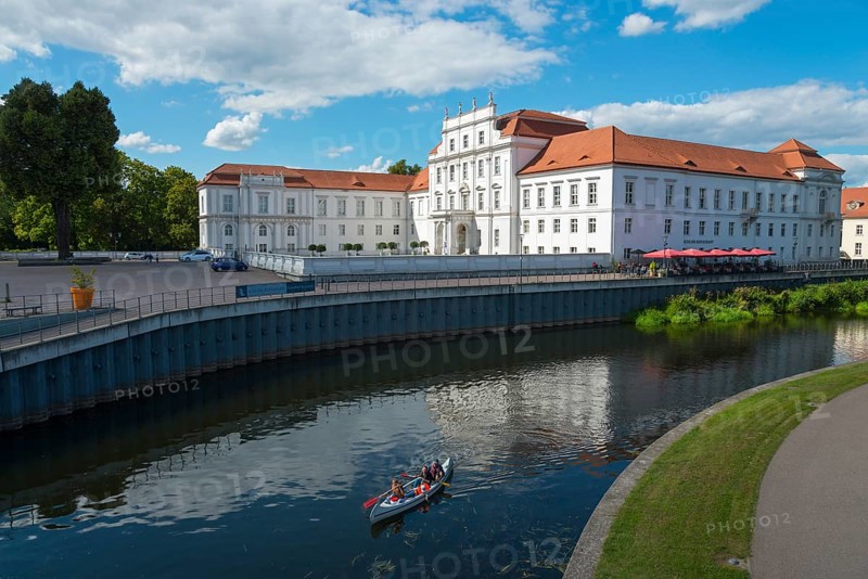 A baroque castle on the water with canoeists and a terrace with a red roof, Oranienburg Castle, museum, Oranienburg, Havel River, Oberhavel district, Brandenburg, Germany, Europe