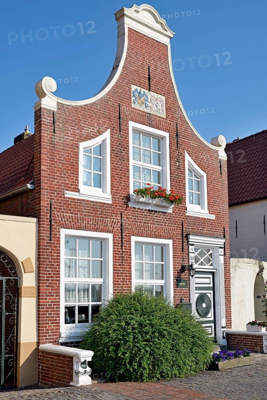 Historic building at the harbour of Greetsiel, blue sky, North Sea, Lower Saxony, Germany, Europe