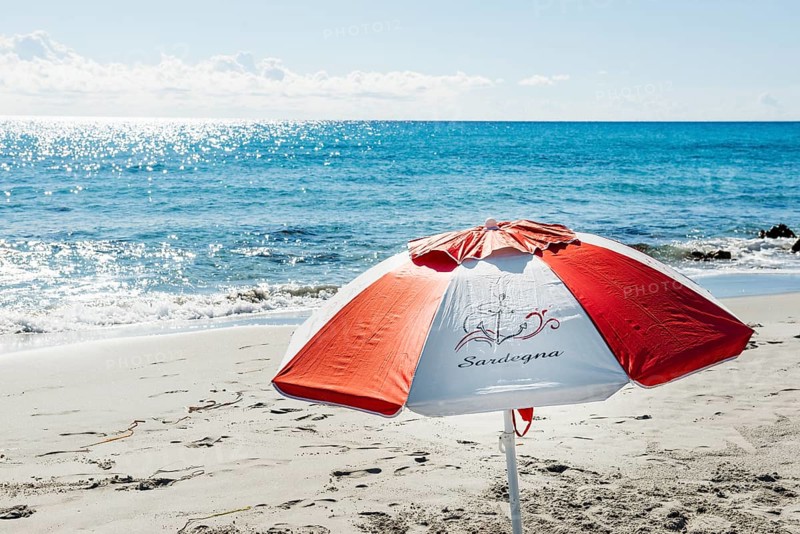 Lonely beach and parasol, Spiaggia di Biderosa, Riserva Biderosa nature reserve, Orosei, Nuoro province, east coast, Sardinia, Italy, Europe