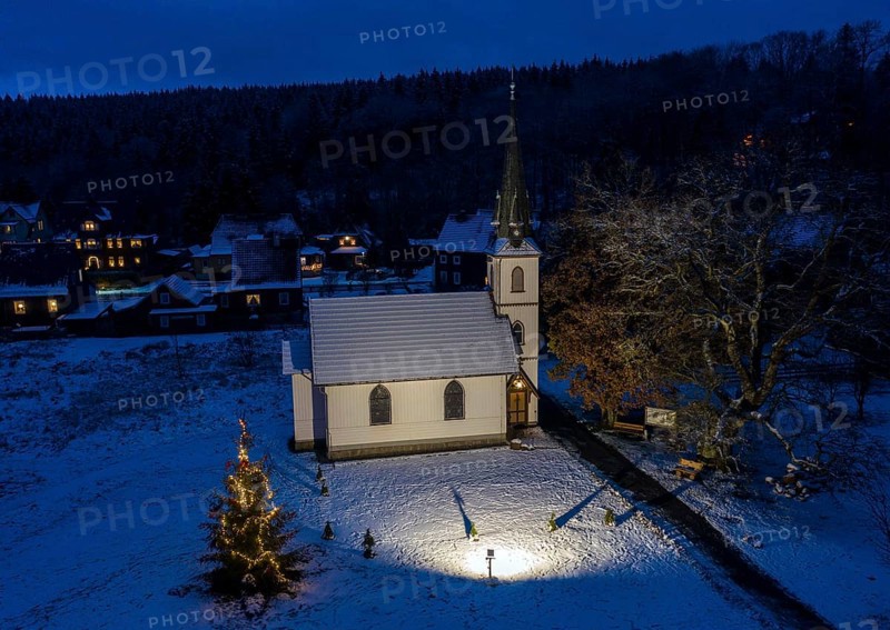 A Christmas tree stands in front of the smallest wooden church in Germany, Elend, 29 December 2020
