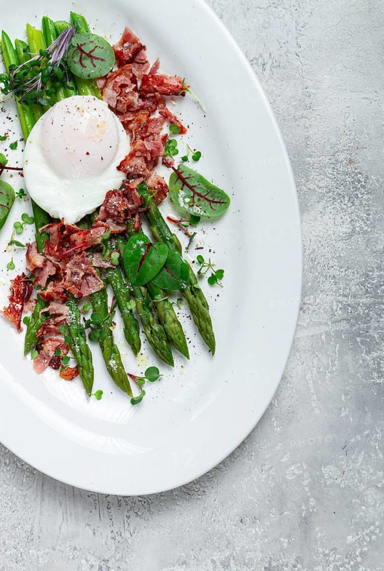 Asparagus with poached egg and fried bacon, micro greens and spices, breakfast, homemade, no people