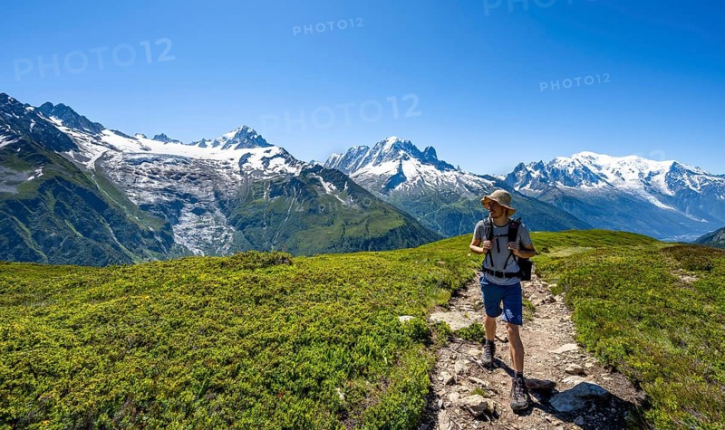Mountaineer in front of mountain panorama with glaciated mountain peaks, Aiguille de Chardonnet with Glacier du Tour, Aiguille Verte with Aiguille du Midi and Mont Blanc, hike to Aiguillette des Posettes, Chamonix, Haute-Savoie, France, Europe