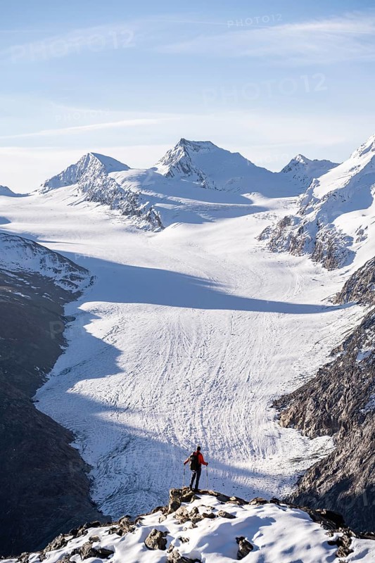 Mountaineer in front of mountain panorama and glacier, view of Gurgler Ferner with summit Hochwilde and Falschungsspitze, in the morning light, Ötztal Alps, Tyrol, Austria, Europe