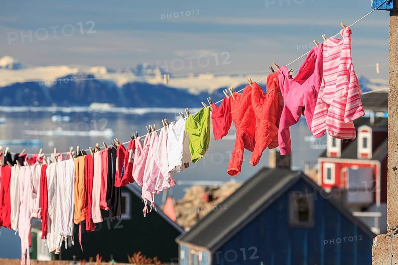 Colourful laundry drying on a washing line in an Inuit settlement, Ittoqqortoormiit, Scoresby Sund, East Greenland, Greenland, North America