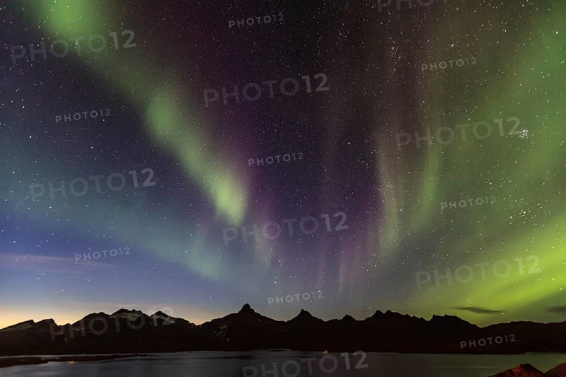Northern Lights, Aurora borealis over a fjord with steep mountains, autumn, Tasiilaq, East Greenland, Greenland, North America