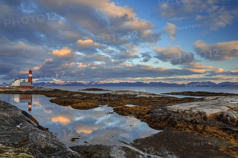Lighthouse reflected in water, cloudy mood, mountains, coast, Tranoy, Ofoten, Norway, Europe