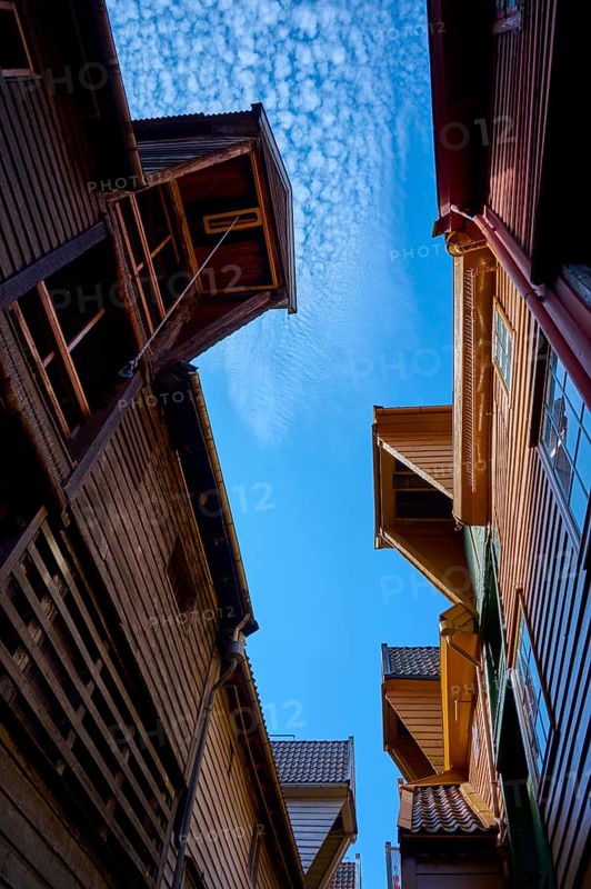 Narrow alley between old half-timbered houses with stairs, dominating wooden architecture in red and brown tones, Historic warehouses, Bryggen, Bergen, Vestland, Norway, Europe