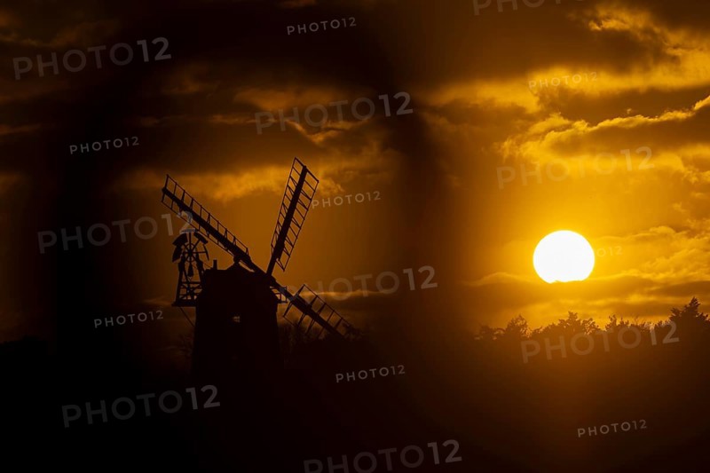 Windmill silhouette at sunset with a red sky and clouds, Cley-next-to-the-sea, Norfolk, England, United Kingdom, Europe