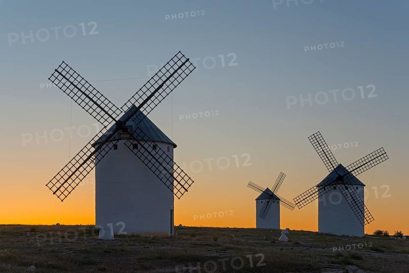 Three windmills at dusk against a colourful sky, Campo de Criptana, Ciudad Real province, Castilla-La Mancha, Don Quixote Route, Spain, Europe