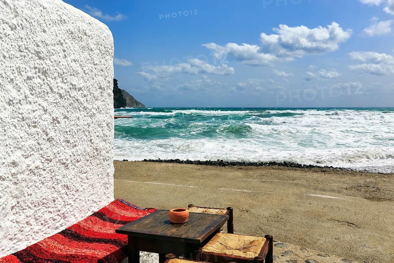 Simple wooden table with bench and stools outside, bar overlooking the sea, beach bar, Cabo de Gata Natural Park, Cabo-de-Gata-Nijar, Las Negras, Almeria, Andalusia, Spain, Europe
