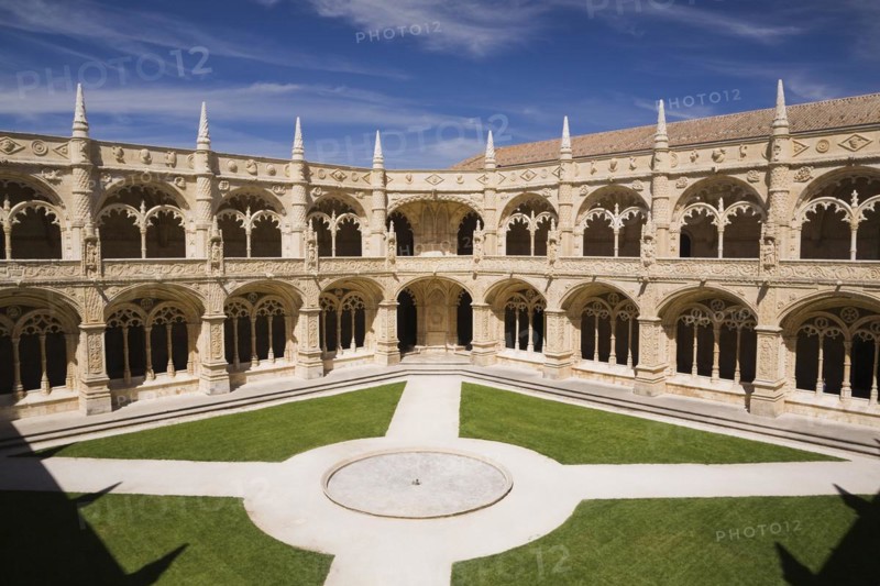 High angle view of the inner coutyard with water fountain in middle of green grass lawn and paved footpaths at Jeronimos Monastery, Lisbon, Portugal, Europe