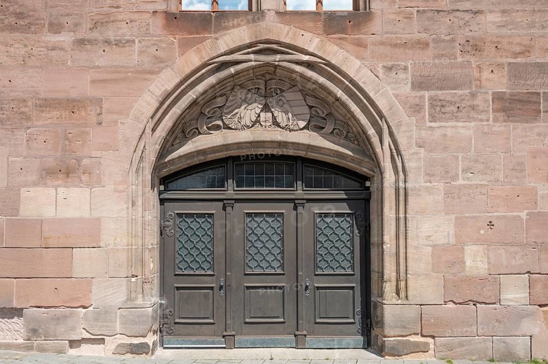 West side with coat of arms above the entrance gate, historic toll hall, built 1498-1502, former granary, Hallplatz 2, Nuremberg, Middle Franconia, Bavaria, Germany, Europe